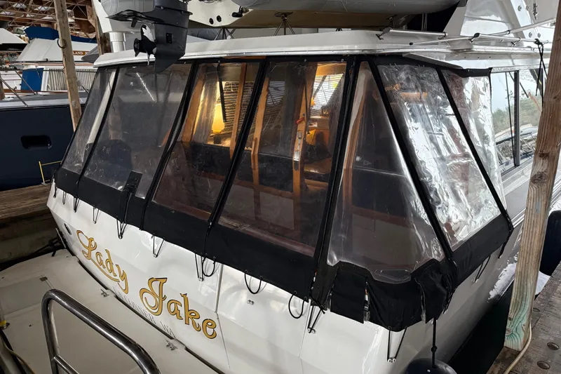 Lady Jake Yacht Photos Pics 1985 Bayliner 4550 Motoryacht docked, featuring enclosed cabin and visible name "Lady Jake."