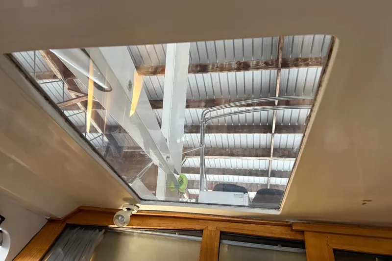 Lady Jake Yacht Photos Pics Interior view of 1985 Bayliner 4550 Motoryacht skylight under a metal roof.