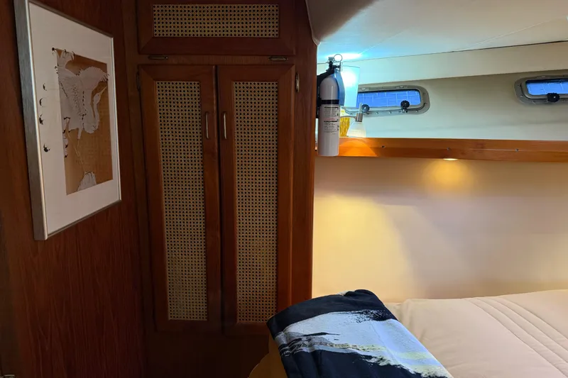 Lady Jake Yacht Photos Pics Interior of 1985 Bayliner 4550 Motoryacht cabin with wooden closet and wall art.
