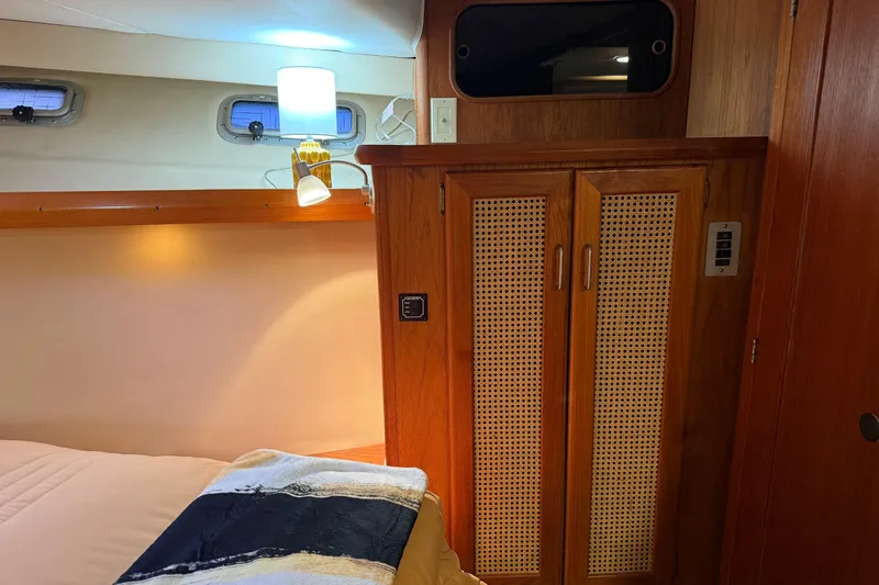 Lady Jake Yacht Photos Pics Interior of 1985 Bayliner 4550 Motoryacht with wooden cabinetry and cozy lighting.