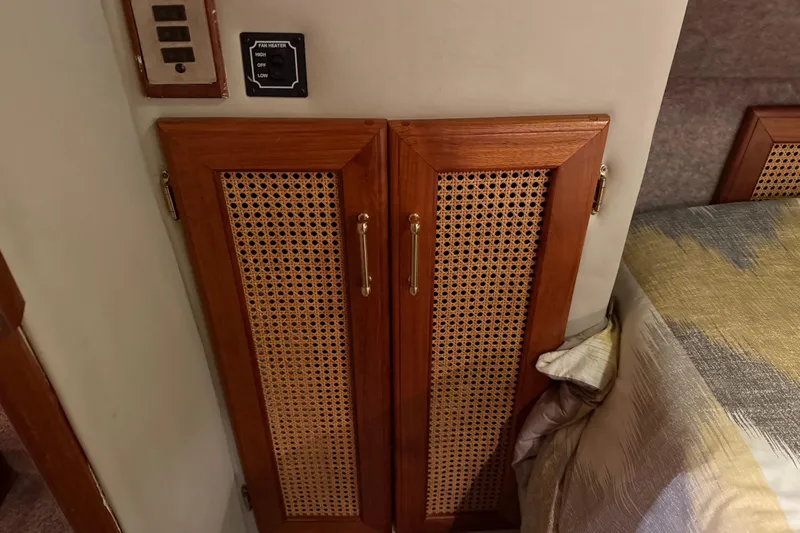 Lady Jake Yacht Photos Pics 1985 Bayliner 4550 Motoryacht interior with wooden cabinet and fan heater controls.