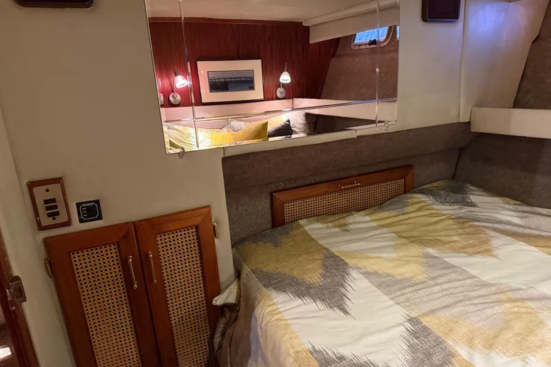 Lady Jake Yacht Photos Pics Interior of 1985 Bayliner 4550 Motoryacht with cozy bedroom and stylish decor.