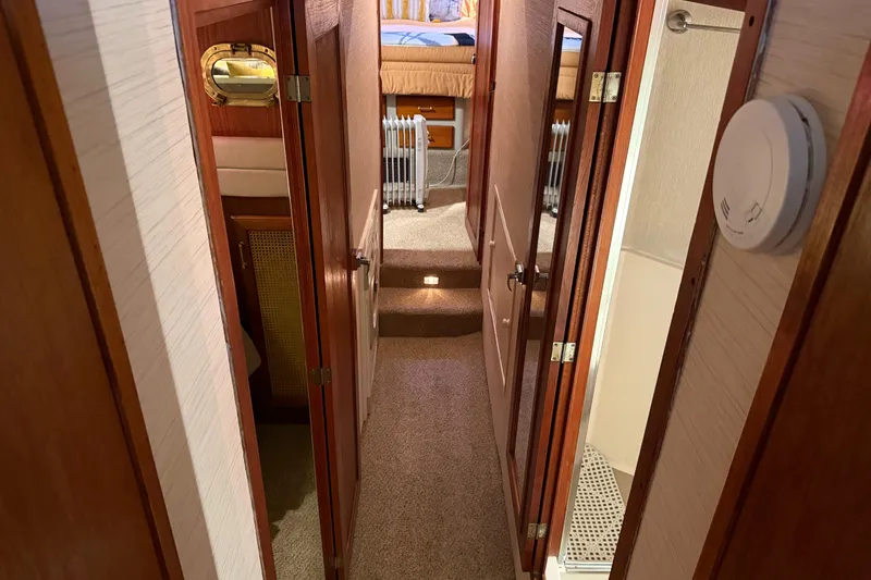Lady Jake Yacht Photos Pics 1985 Bayliner 4550 Motoryacht interior hallway with wooden doors and carpeted floor.
