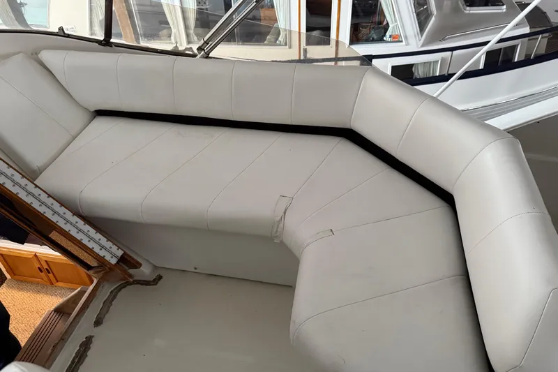 Lady Jake Yacht Photos Pics 1985 Bayliner 4550 Motoryacht interior with white cushioned seating area.