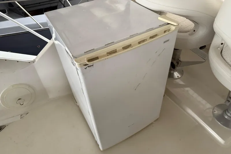 Lady Jake Yacht Photos Pics White refrigerator on 1985 Bayliner 4550 Motoryacht deck, next to seating.