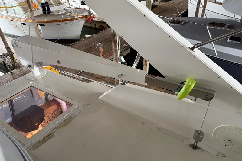 Lady Jake Yacht Photos Pics 1985 Bayliner 4550 Motoryacht deck with davit system and docked boats in background.