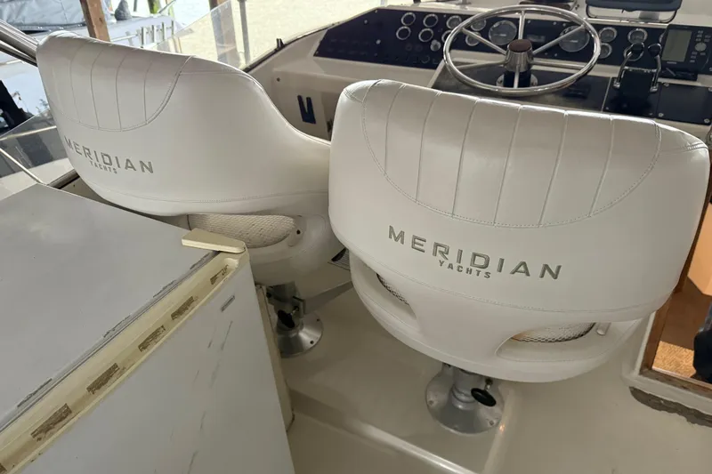 Lady Jake Yacht Photos Pics Captain's chairs on 1985 Bayliner 4550 Motoryacht, featuring Meridian Yachts branding.