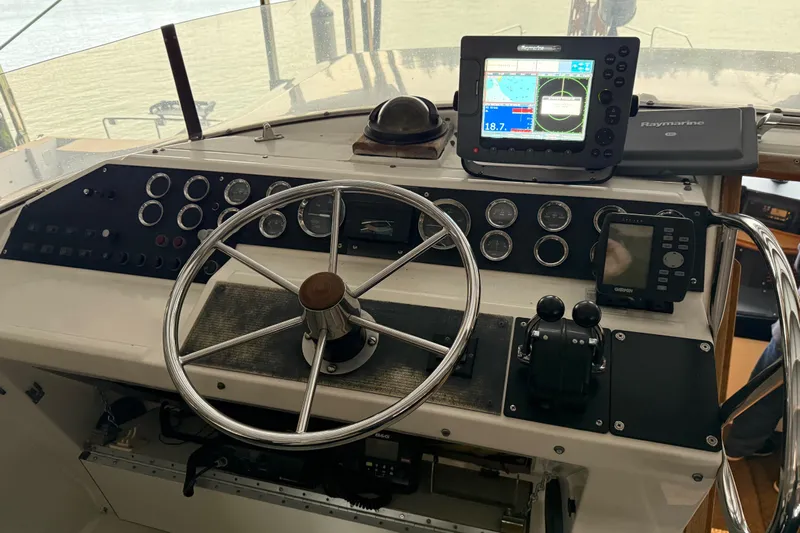 Lady Jake Yacht Photos Pics 1985 Bayliner 4550 Motoryacht helm with steering wheel, gauges, and navigation equipment.
