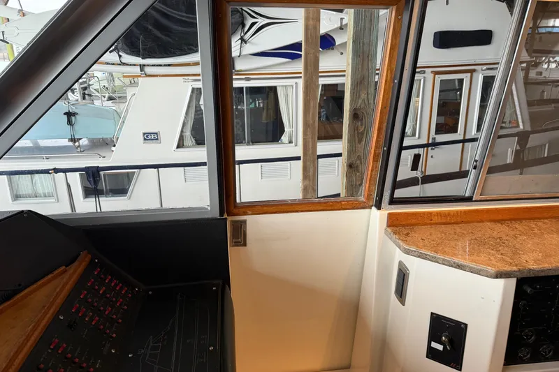Lady Jake Yacht Photos Pics Interior view of 1985 Bayliner 4550 Motoryacht helm with control panel and window.