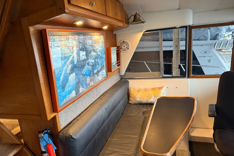 Lady Jake Yacht Photos Pics Interior of 1985 Bayliner 4550 Motoryacht with artwork and seating area.