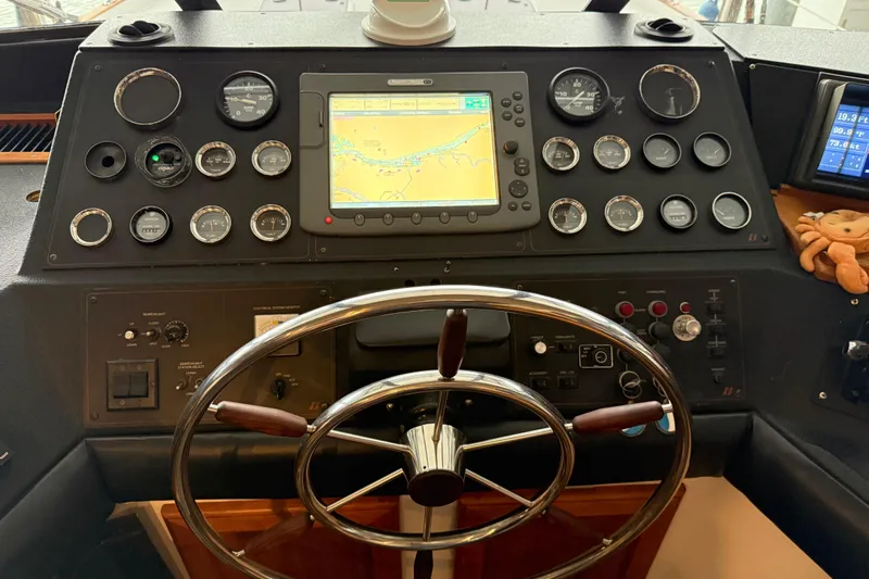 Lady Jake Yacht Photos Pics Dashboard of a 1985 Bayliner 4550 Motoryacht with navigation instruments and steering wheel.