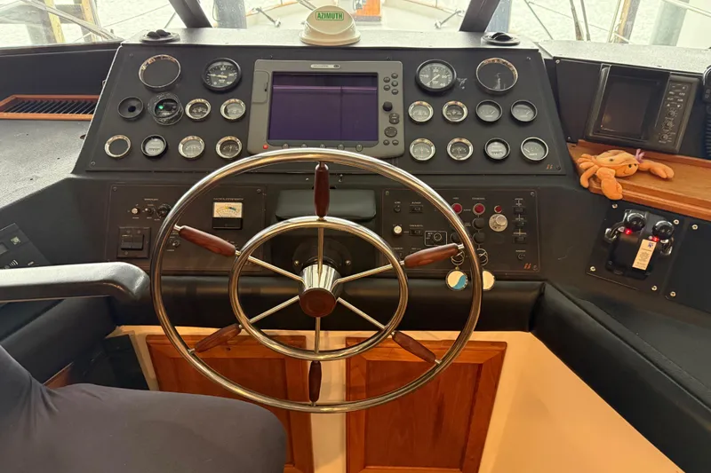 Lady Jake Yacht Photos Pics 1985 Bayliner 4550 Motoryacht helm with steering wheel and control panel.