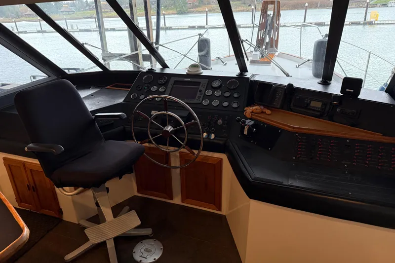 Lady Jake Yacht Photos Pics 1985 Bayliner 4550 Motoryacht helm with steering wheel, controls, and panoramic windows.