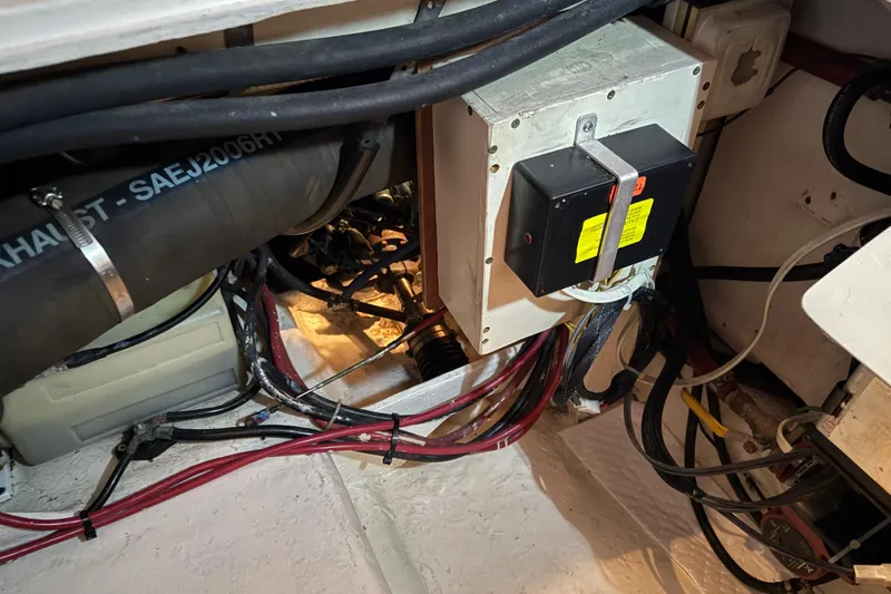 Lady Jake Yacht Photos Pics Engine compartment of 1985 Bayliner 4550 Motoryacht with wiring and exhaust hose.