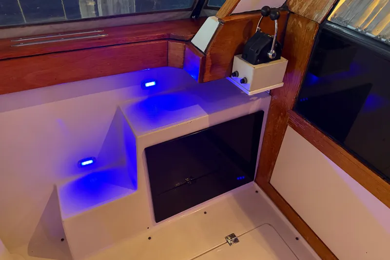 Lady Jake Yacht Photos Pics Interior of 1985 Bayliner 4550 Motoryacht with blue LED lights and wooden accents.