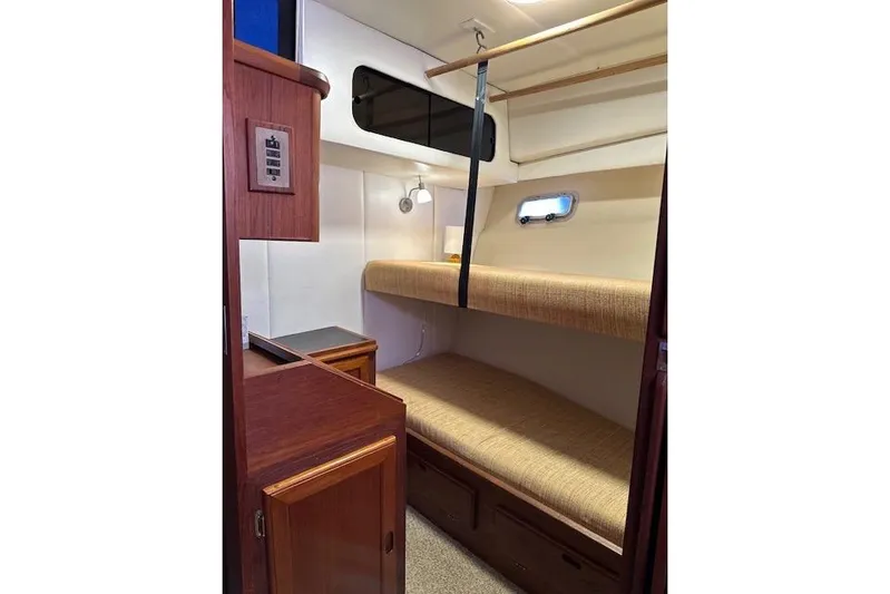 Lady Jake Yacht Photos Pics 1985 Bayliner 4550 Motoryacht interior cabin with bunk beds and wooden cabinetry.