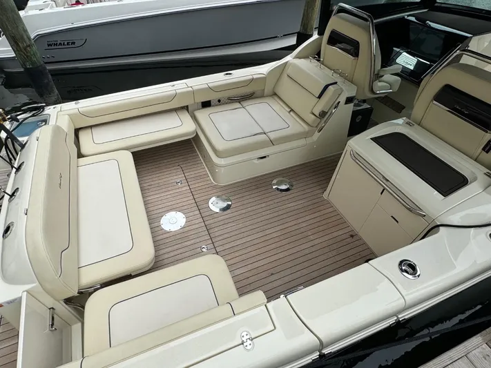  Yacht Photos Pics 2022 Chris-Craft CALYPSO 35 CP boat interior with beige seating and wooden deck.