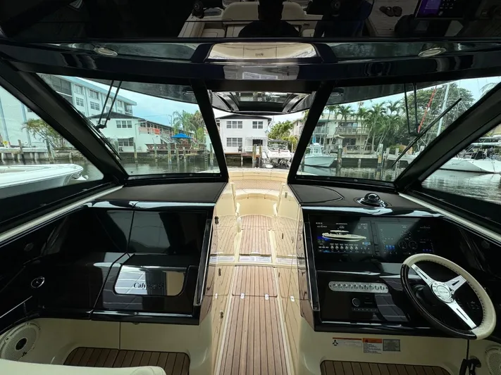  Yacht Photos Pics Interior view of 2022 Chris-Craft CALYPSO 35 CP boat with modern dashboard and steering wheel.
