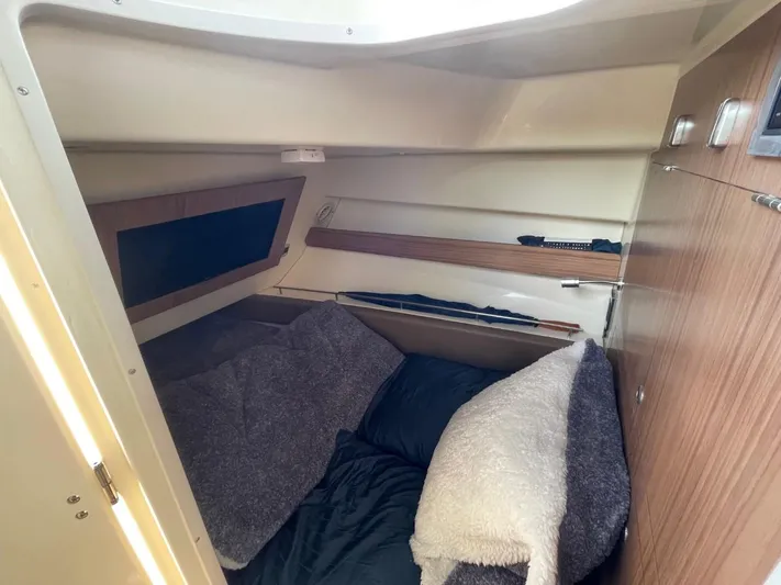  Yacht Photos Pics Cozy cabin interior of 2022 Chris-Craft CALYPSO 35 CP with bedding and wooden accents.
