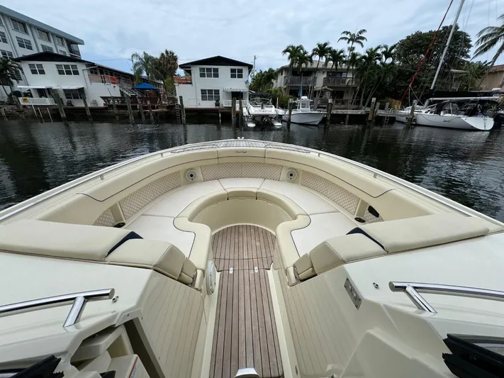  Yacht Photos Pics 2022 Chris-Craft CALYPSO 35 CP boat with spacious seating, docked near waterfront homes.