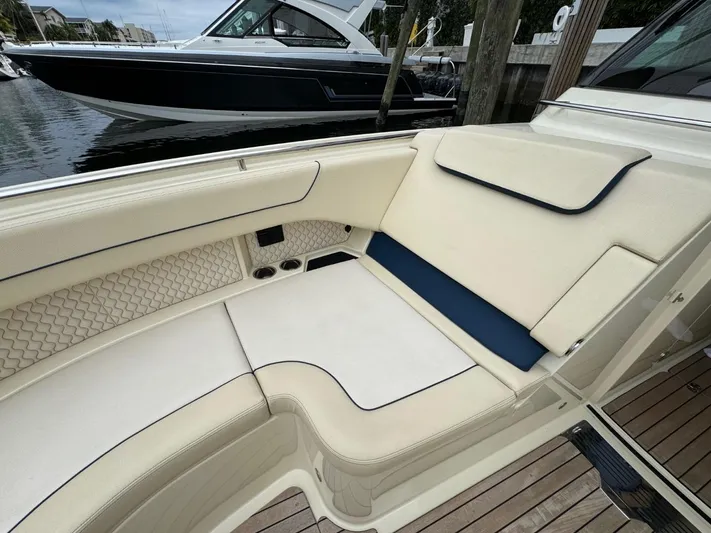 Yacht Photos Pics 2022 Chris-Craft CALYPSO 35 CP boat interior with cream seating and blue accents.