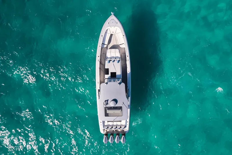  Yacht Photos Pics Aerial view of Midnight Express 43' Solstice boat on turquoise water.