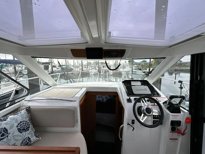 Something Special Yacht Photos Pics Interior view of 2016 Jeanneau Merry Fisher 855 boat cockpit with steering wheel.
