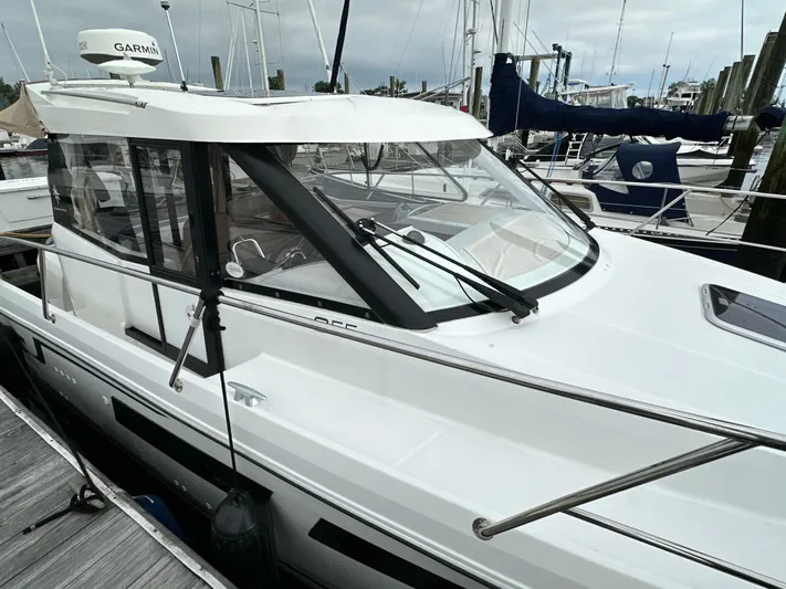 Something Special Yacht Photos Pics 2016 Jeanneau Merry Fisher 855 boat docked at marina, featuring sleek design and Garmin equipment.