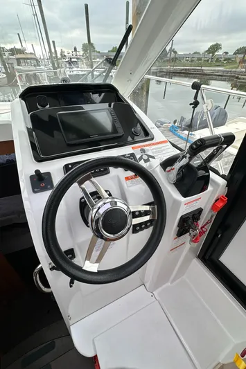 Something Special Yacht Photos Pics 2016 Jeanneau Merry Fisher 855 helm with steering wheel and control panel.