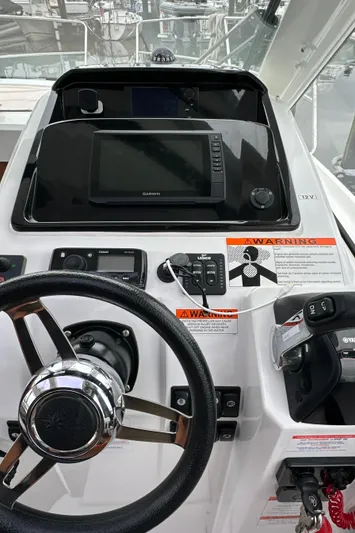 Something Special Yacht Photos Pics Helm of 2016 Jeanneau Merry Fisher 855 with navigation equipment and controls.