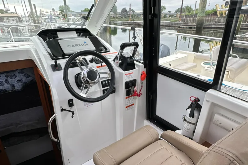 Something Special Yacht Photos Pics 2016 Jeanneau Merry Fisher 855 helm with Garmin navigation system and comfortable seating.