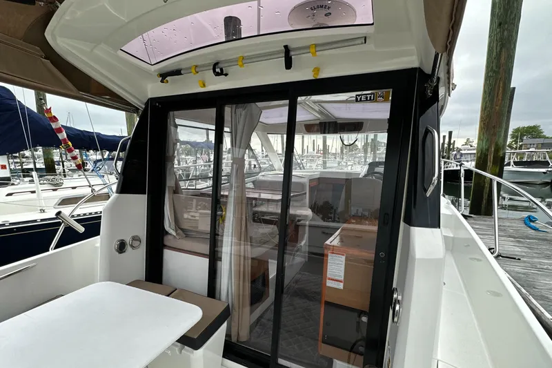 Something Special Yacht Photos Pics 2016 Jeanneau Merry Fisher 855 boat with sliding glass doors and marina view.