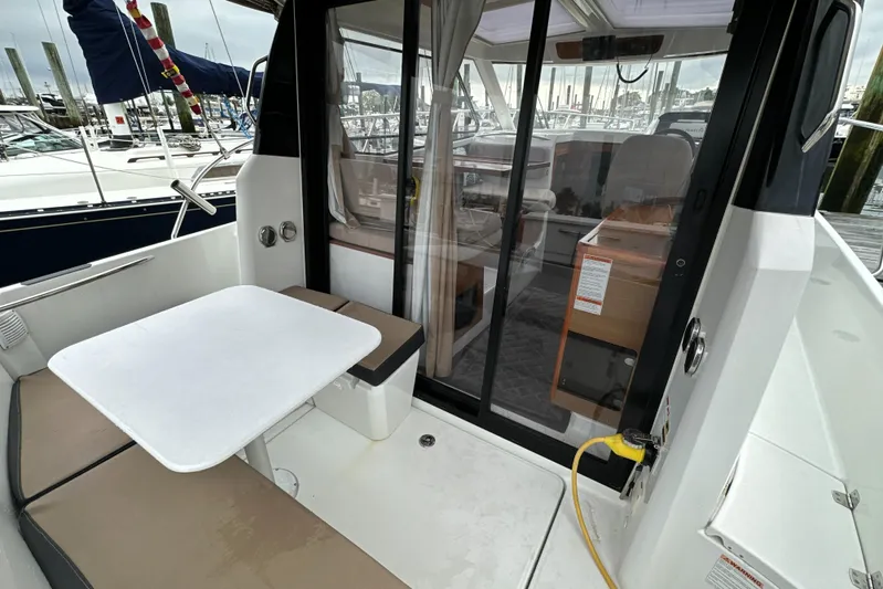 Something Special Yacht Photos Pics 2016 Jeanneau Merry Fisher 855 boat interior with seating and table.