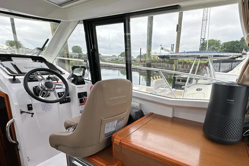 Something Special Yacht Photos Pics Interior of 2016 Jeanneau Merry Fisher 855 boat, featuring helm and seating area.