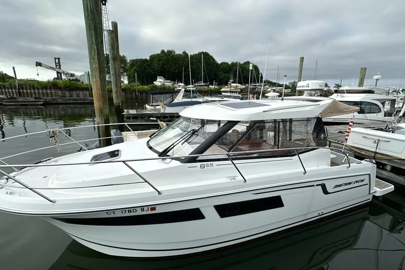 Something Special Yacht Photos Pics 2016 Jeanneau Merry Fisher 855 boat docked in a marina, overcast sky.