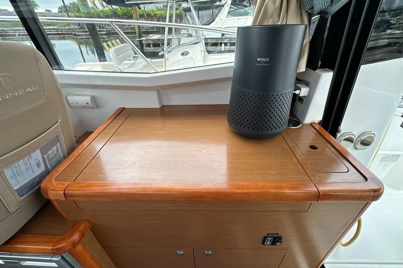 Something Special Yacht Photos Pics 2016 Jeanneau Merry Fisher 855 interior with wooden cabinetry and a Winix air purifier.