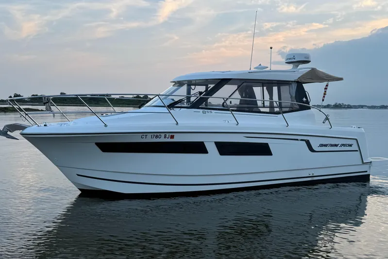 Something Special Yacht Photos Pics 2016 Jeanneau Merry Fisher 855 boat on calm water at sunset.
