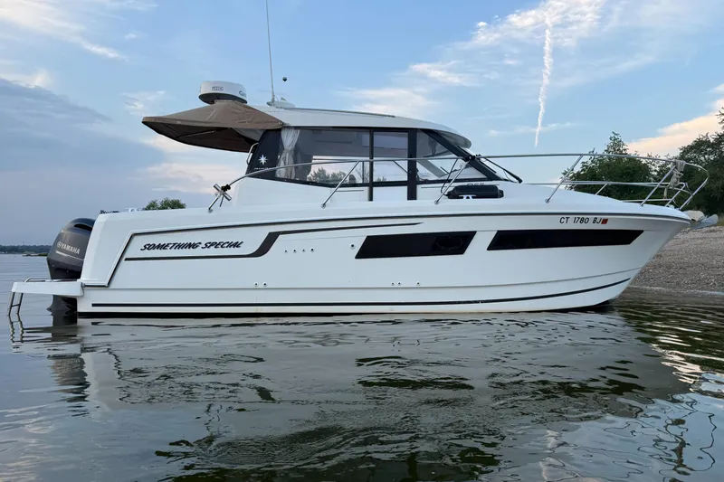 Something Special Yacht Photos Pics 2016 Jeanneau Merry Fisher 855 boat on calm water, side view.