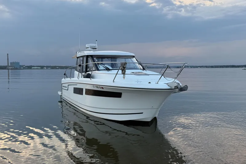 Something Special Yacht Photos Pics 2016 Jeanneau Merry Fisher 855 boat on calm water under cloudy sky.