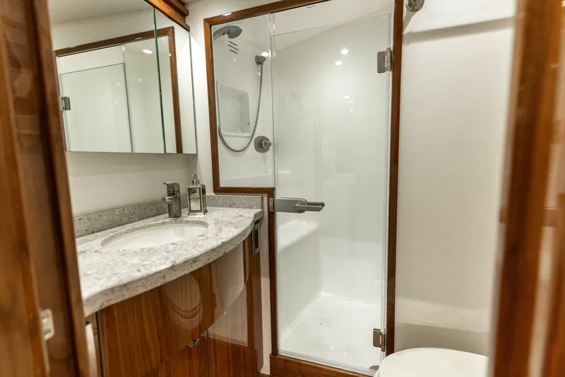 Galati Yacht Sales Trade Yacht Photos Pics Luxurious bathroom in 2020 Viking 62 Convertible yacht with modern shower and elegant vanity.