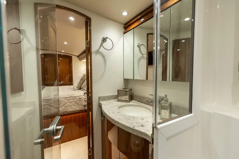 Galati Yacht Sales Trade Yacht Photos Pics Luxurious bathroom interior of 2020 Viking 62 Convertible yacht with modern fixtures.