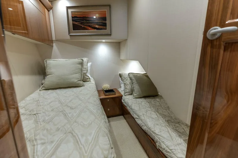 Galati Yacht Sales Trade Yacht Photos Pics Luxurious twin cabin interior of 2020 Viking 62 Convertible yacht with elegant bedding.