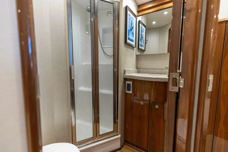 Galati Yacht Sales Trade Yacht Photos Pics Luxurious bathroom in 2020 Viking 62 Convertible yacht with shower and wooden cabinetry.
