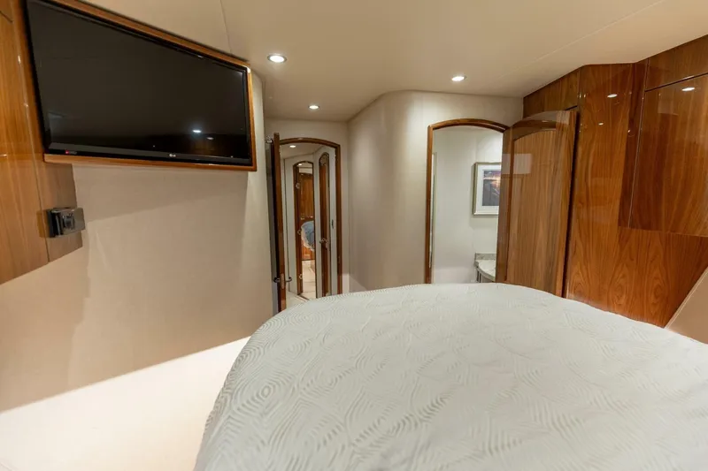 Galati Yacht Sales Trade Yacht Photos Pics Luxurious interior of 2020 Viking 62 Convertible yacht with TV and wood paneling.