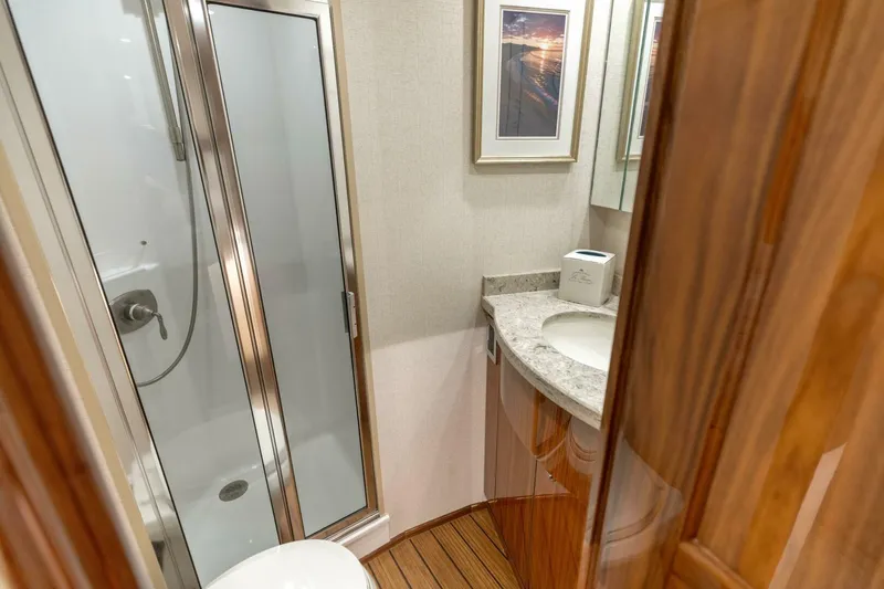 Galati Yacht Sales Trade Yacht Photos Pics Luxurious bathroom in 2020 Viking 62 Convertible yacht with shower and elegant wood finishes.