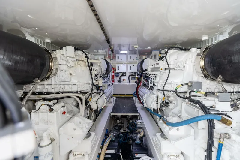 Galati Yacht Sales Trade Yacht Photos Pics Engine room of a 2020 Viking 62 Convertible yacht, showcasing dual powerful engines.