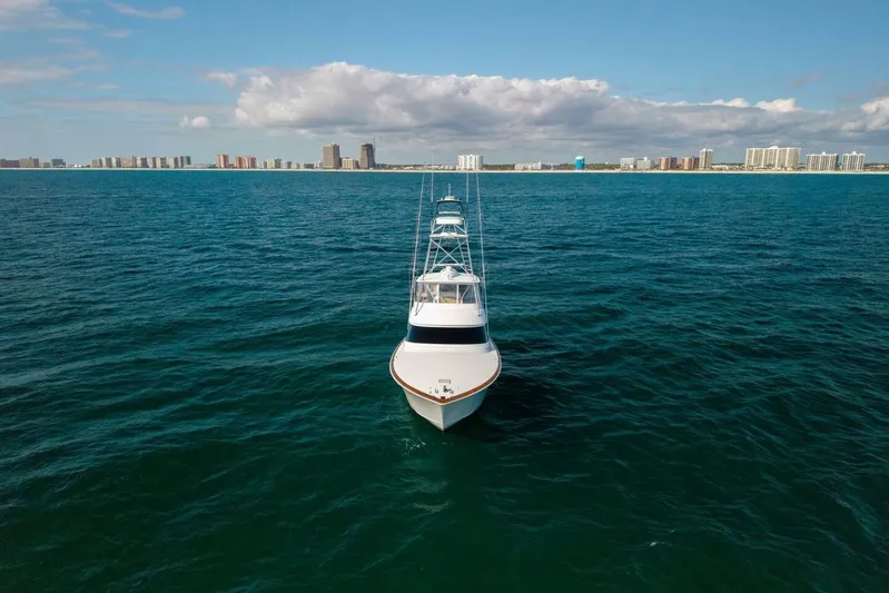 Galati Yacht Sales Trade Yacht Photos Pics 2020 Viking 62 Convertible yacht on open sea with city skyline in background.