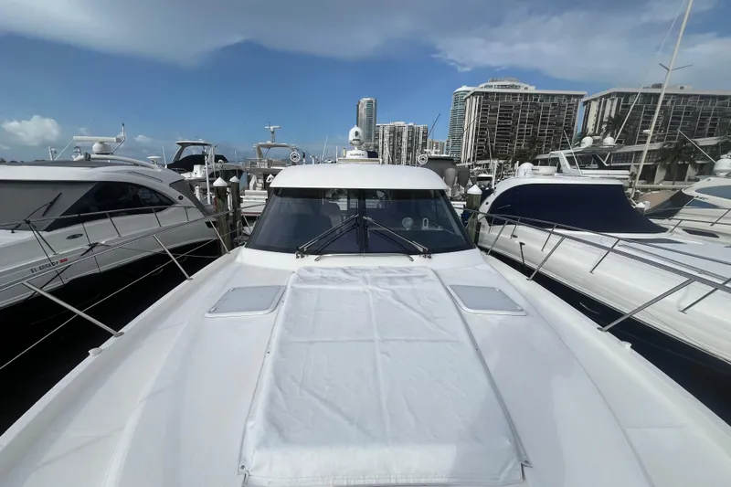  Yacht Photos Pics 2015 Riviera 5000 Sport Yacht docked at marina with city skyline backdrop.