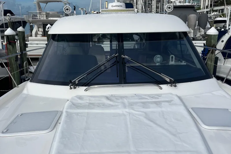  Yacht Photos Pics 2015 Riviera 5000 Sport Yacht docked, showcasing sleek windshield and modern design.