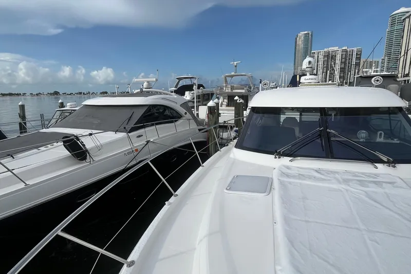  Yacht Photos Pics 2015 Riviera 5000 Sport Yacht docked at marina with city skyline background.